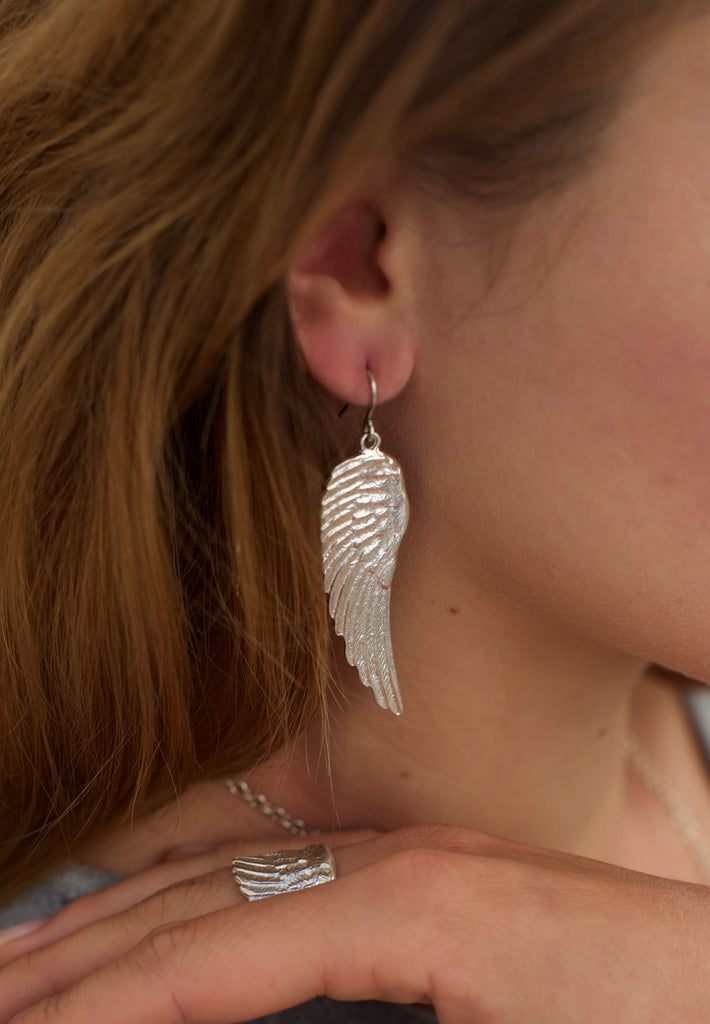 Model showing the silver angel wing earrings by Jennifer Kinnear