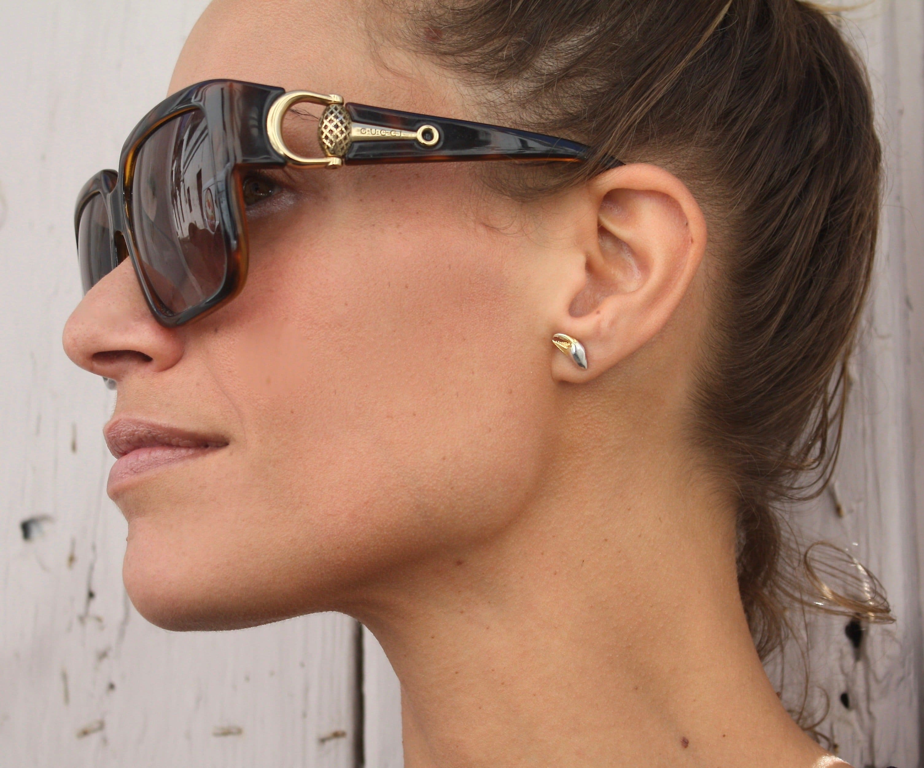 Model with glasses wearing the goldplated and silver crab claw earrings - Jennifer Kinnear Jewellery