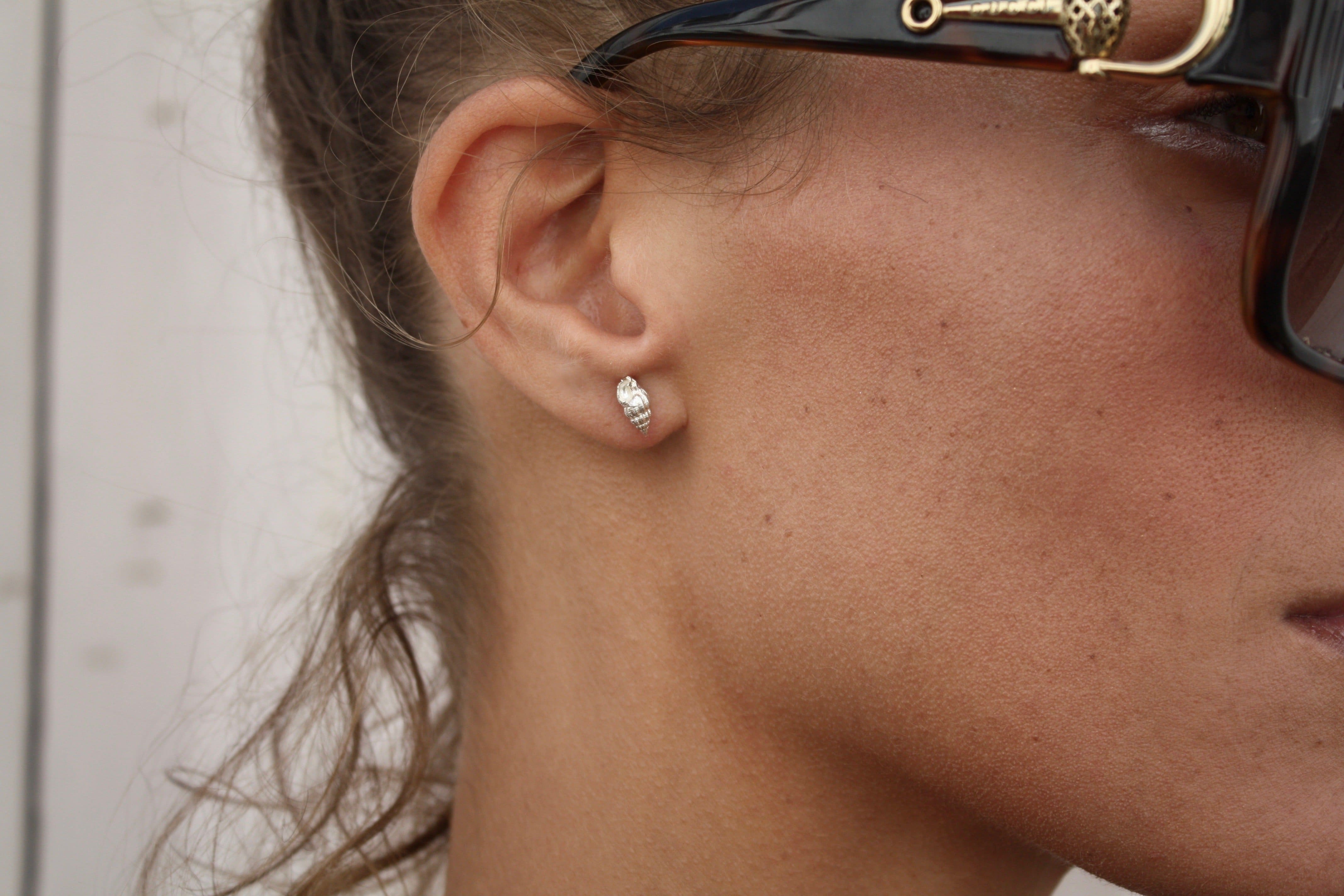 Model wearing silver whelk stud earrings - Ocean Collection - Jennifer Kinnear Jewellery